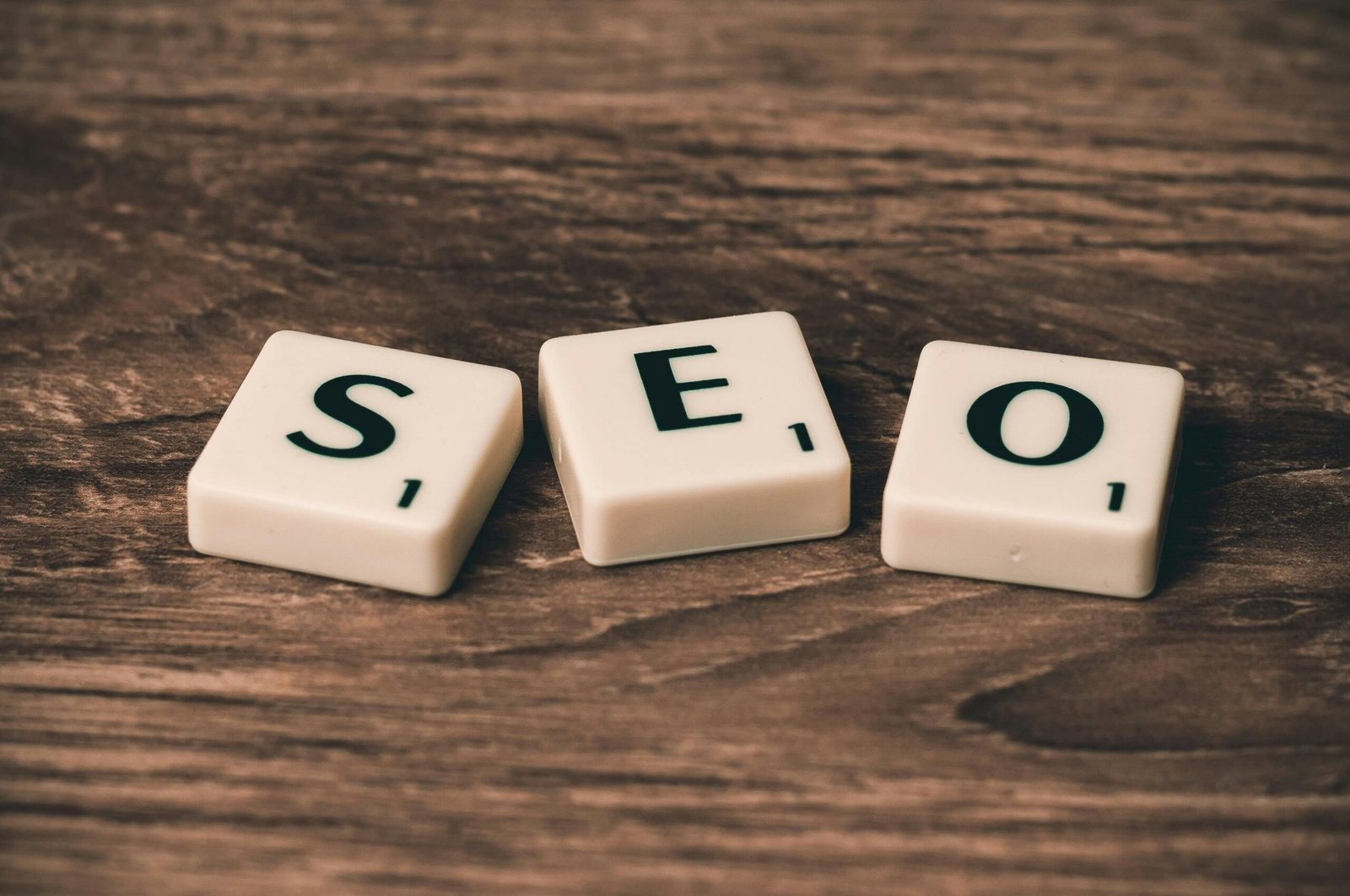 pexels-photo-270637-270637 Scrabble tiles spelling 'SEO' on a wooden surface. Ideal for digital marketing themes.